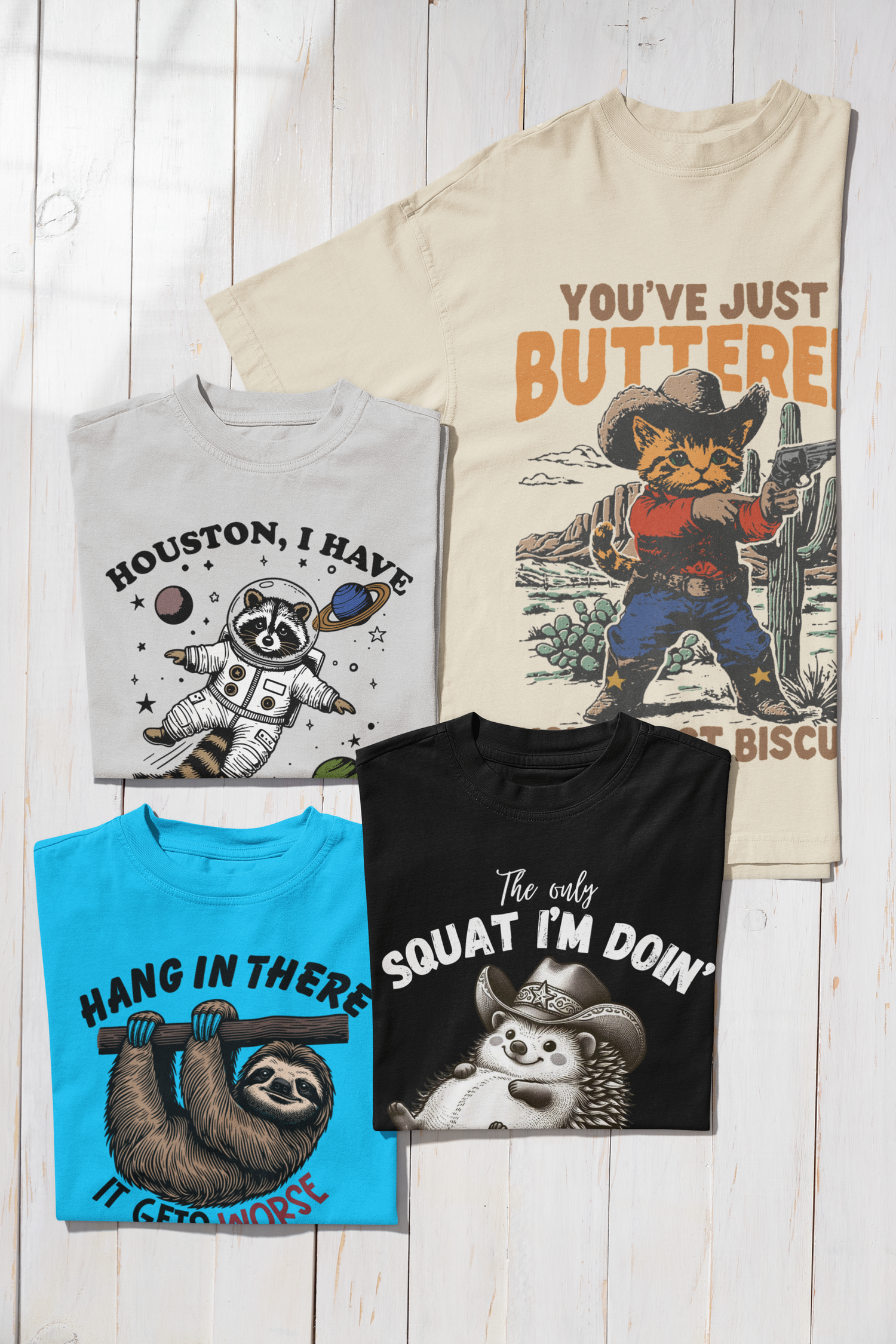 Four laugh out loud t-shirt adult size designs on wood background.